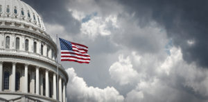 Panoramic view of the United States Capitol and waving american flag in Washington DC