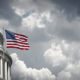 Panoramic view of the United States Capitol and waving american flag in Washington DC