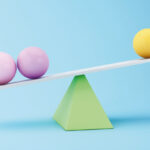 Graphic of two purple spheres and one yellow sphere balancing on top of a green triangle