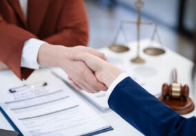 Professionals shaking hands in lawyer office