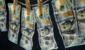 Laundered dollars hanging on a rope with clothespins