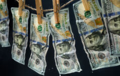 Laundered dollars hanging on a rope with clothespins