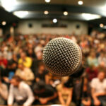 A mic in front of a packed theater.