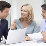 Mature Couple Meeting With Financial Advisor At Home
