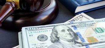Litigation finance. Gavel and dollar banknotes. Bail bonds.