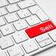 Red Sell button on a white keyboard isolated on a white background