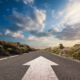 Image of a road with an arrow pointing forward.