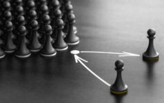 Puzzle pieces on a board with arrows, symbolizing planning.