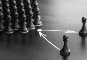 Puzzle pieces on a board with arrows, symbolizing planning.