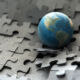 Graphic of a globe on a puzzle that is breaking.