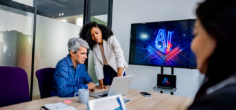 Coworkers collaborating on AI project during business meeting in office