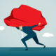 A businessman struggling to walk as he carries an enormous rock on his shoulders, symbolising a burden