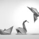 In the Loop: Corner shots Image of a crumpled up piece of paper next to a paper boat that is next to an origami crane that is next to an origami bird, symbolizing the process of changing for success.